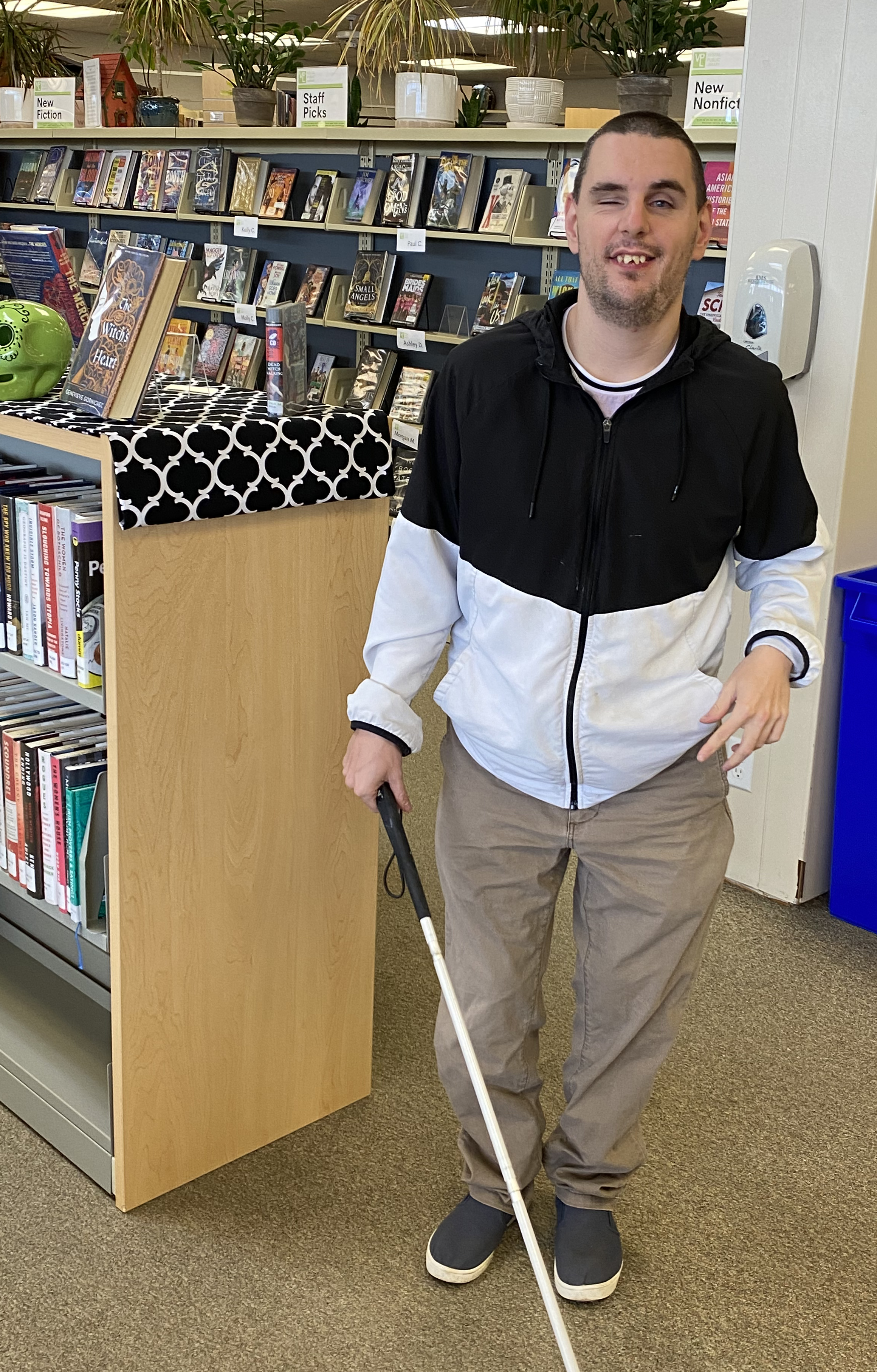Kyle standing in the library